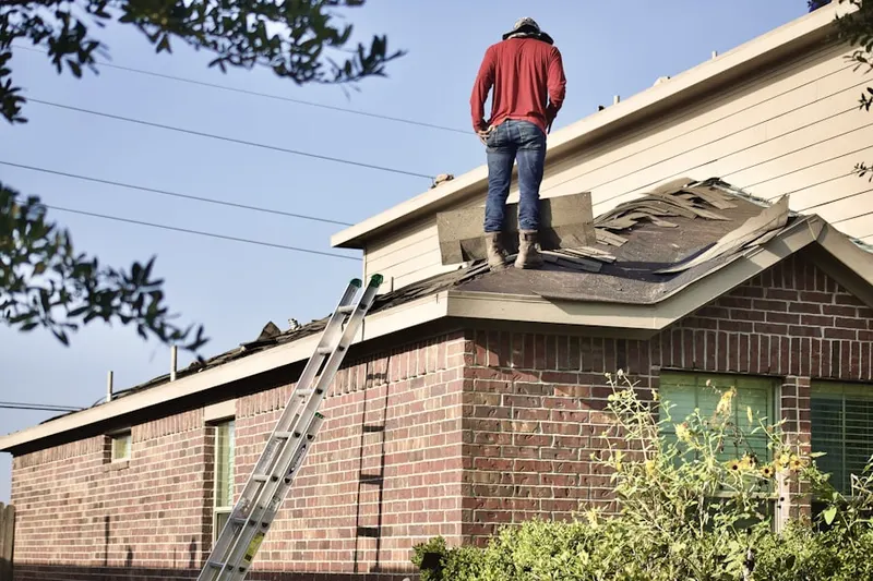Professional roofer working on a residential roof in Big Bear City